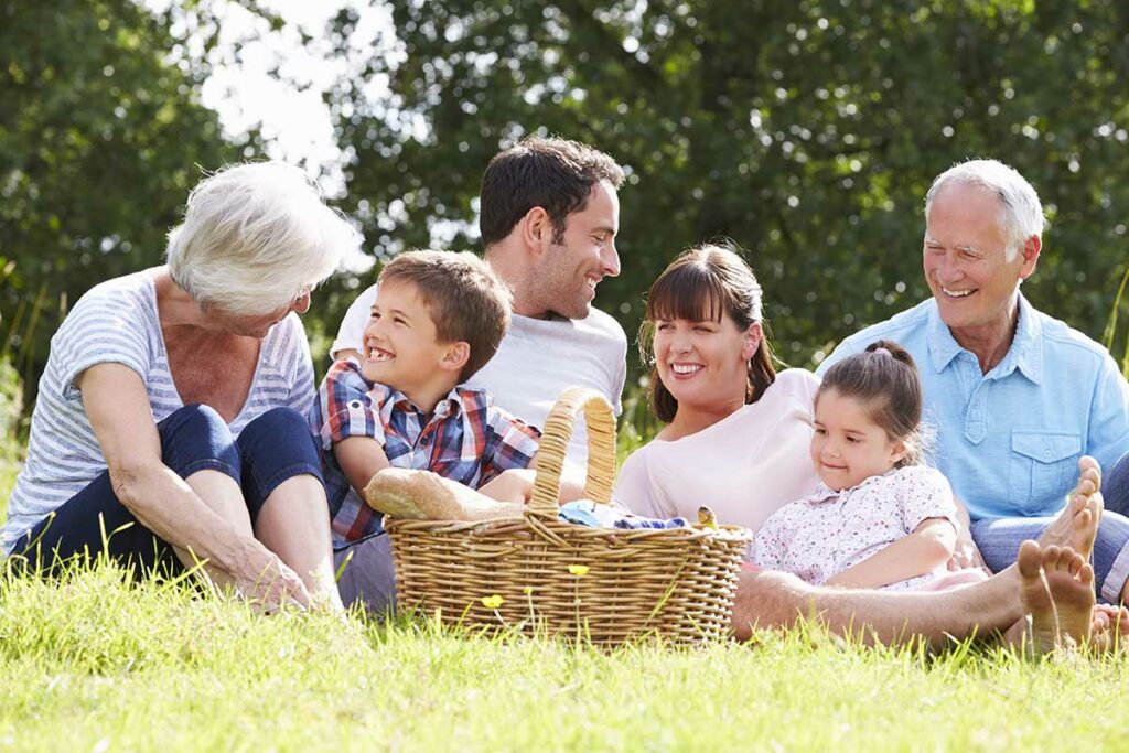 Multi Generation Family Enjoying Picnic In Countryside