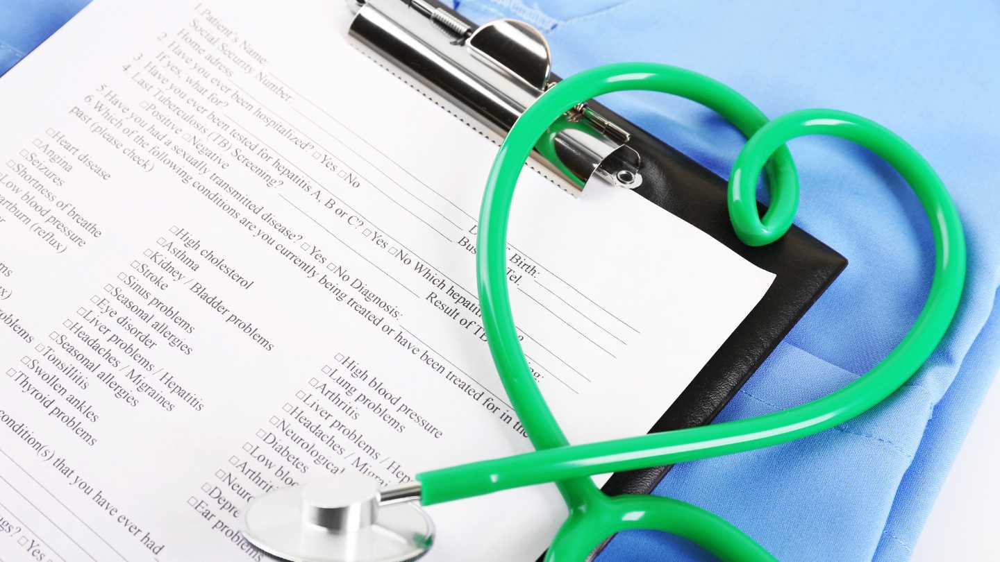 A clipboard with medical doc and green stethoscope shaped in a heart for a blog on advance health directives.