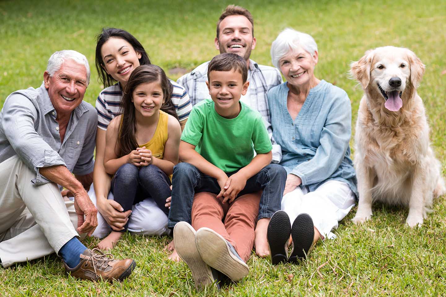 Happy family sitting in the park who just created an asset protection trust